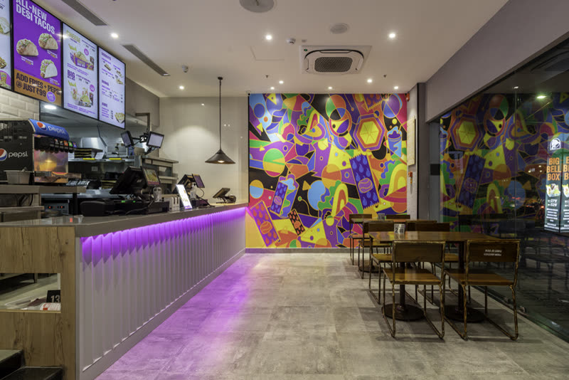 Taco Bell seating area under a lit ceiling
